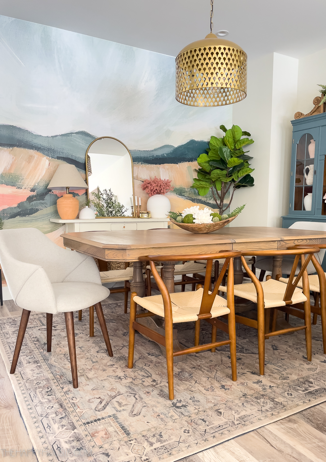 Landscape mural wallpaper above a dining area